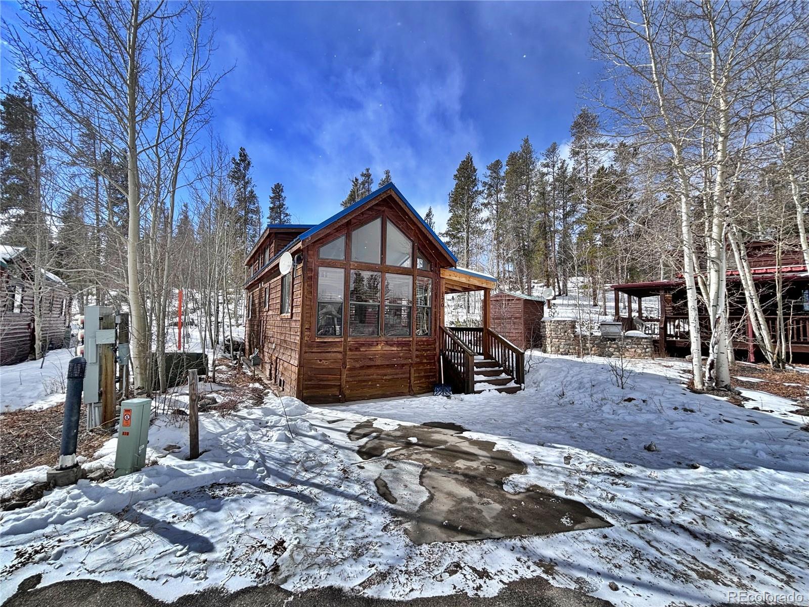 a view of a house with a yard covered in snow