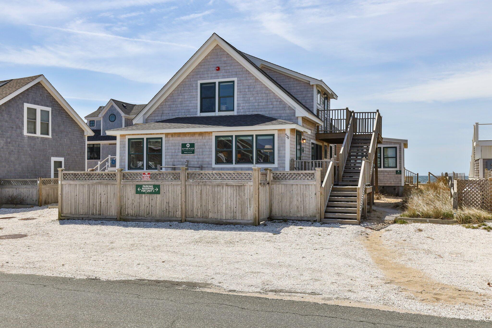 a view of a house with a wooden fence