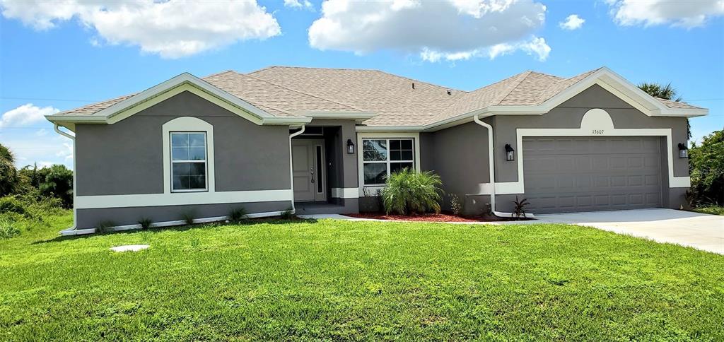 a front view of a house with a yard and garage