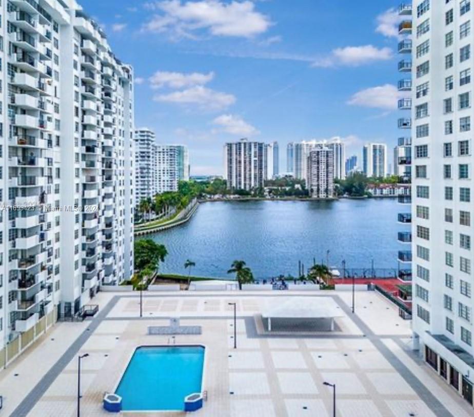 a view of building with outdoor space and lake view