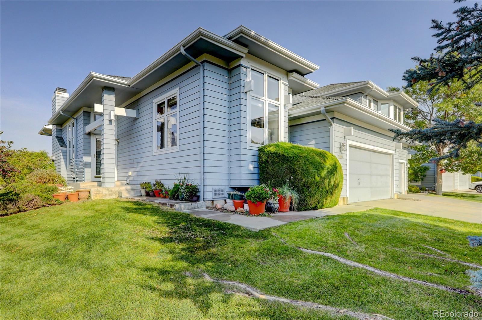 a front view of house with yard and green space