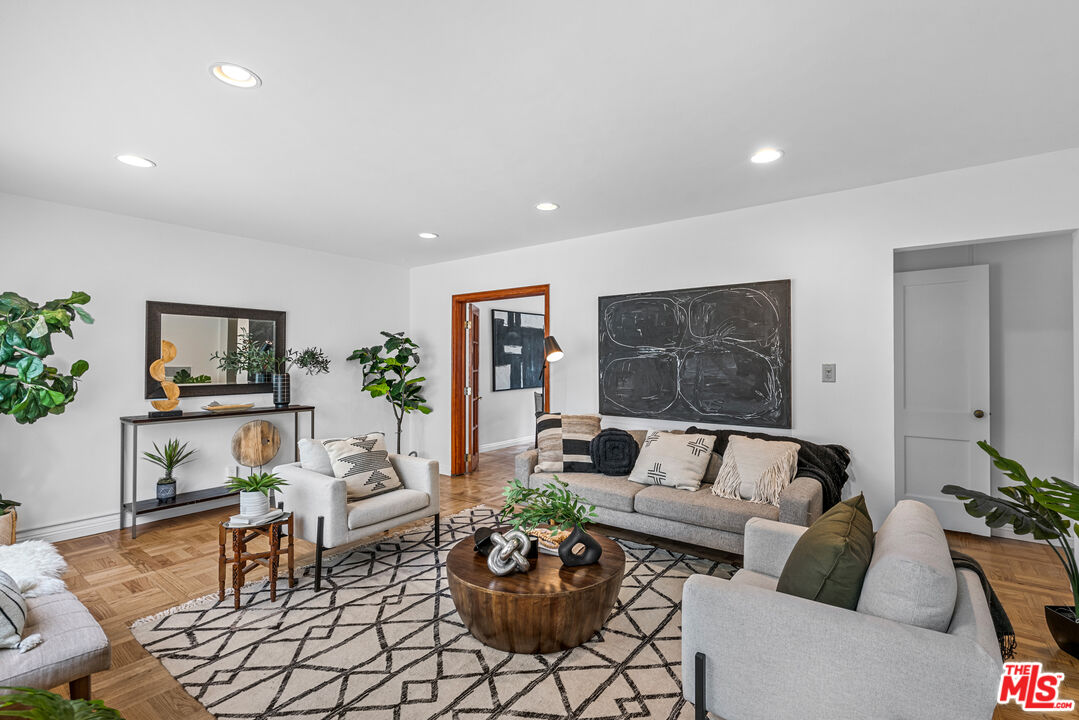 a living room with furniture and a potted plant