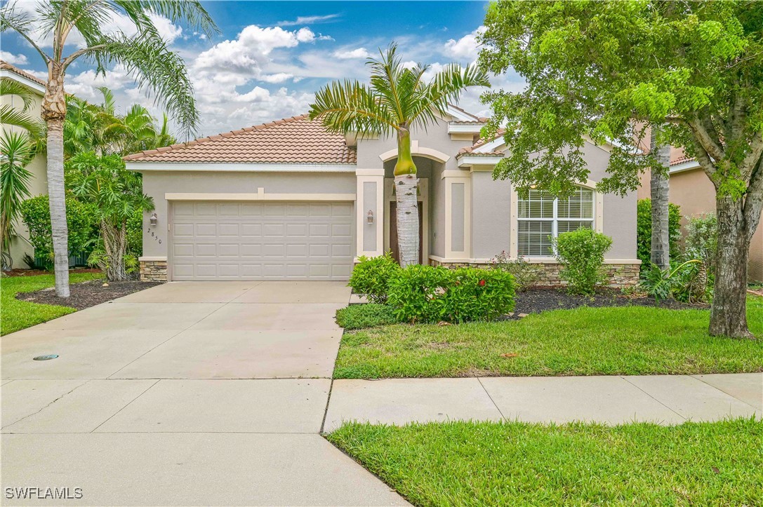 a front view of a house with a yard and garage