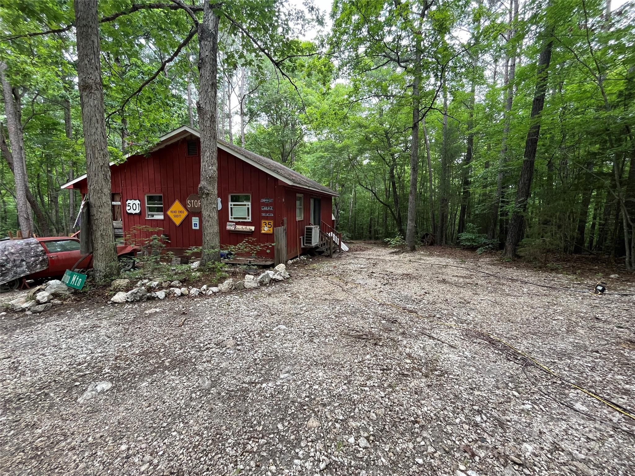 a view of a small house with a yard