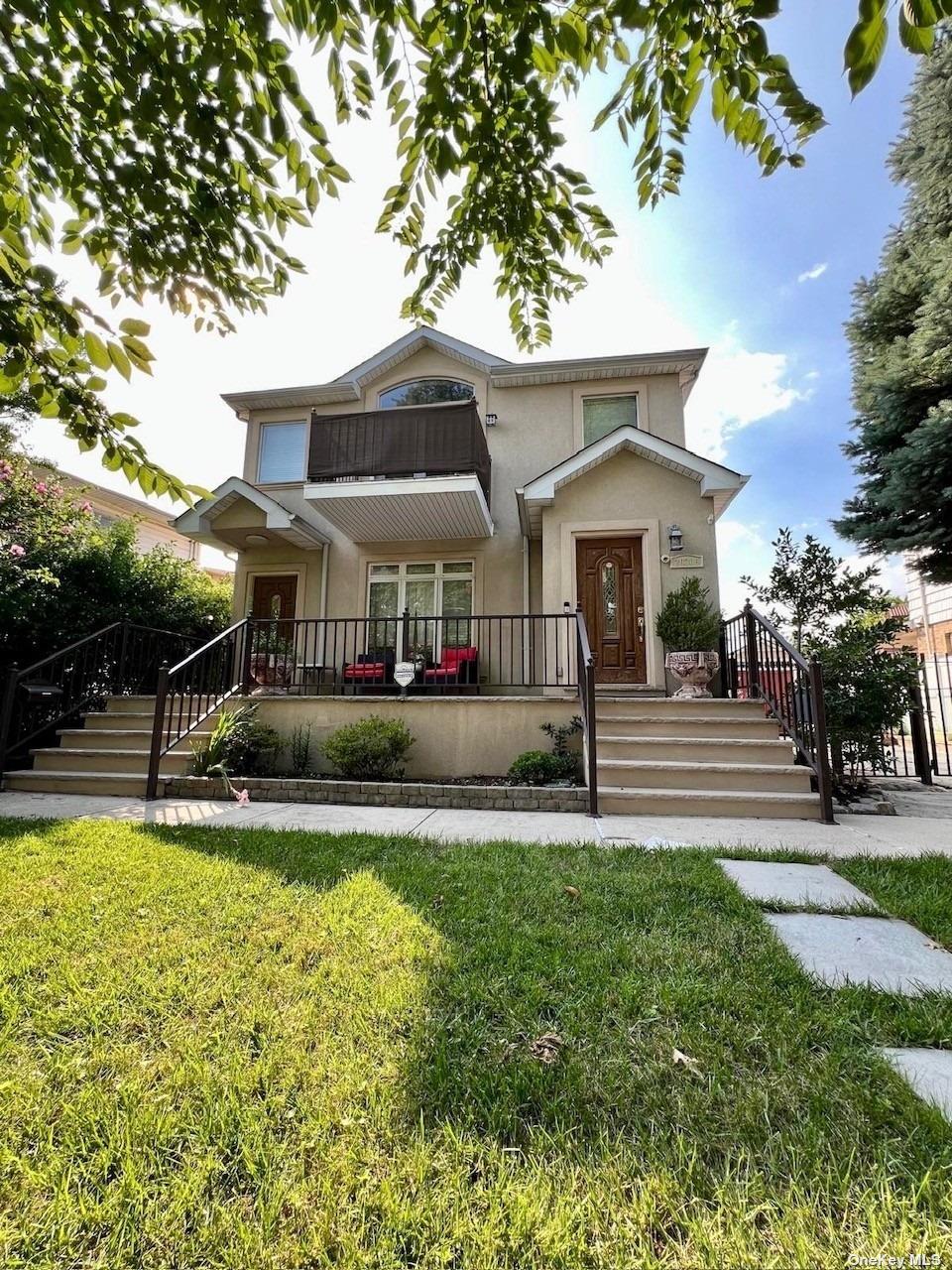 a front view of a house with swimming pool and next to a yard