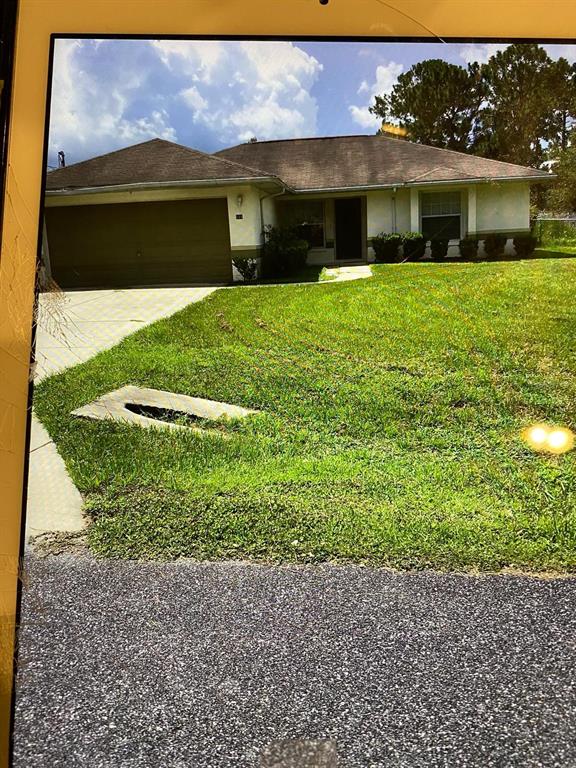 a view of house with yard