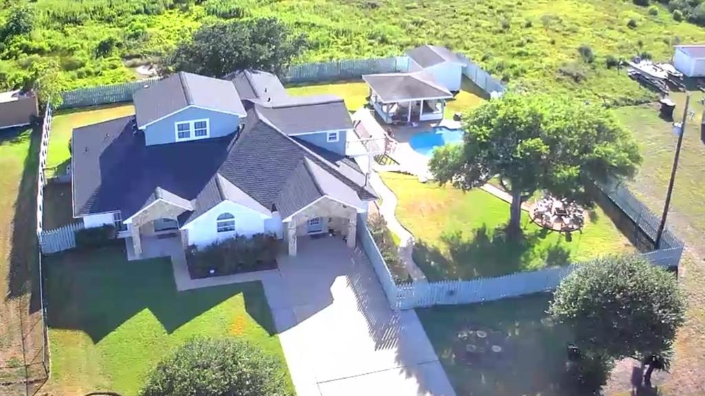 an aerial view of a house with swimming pool and outdoor space