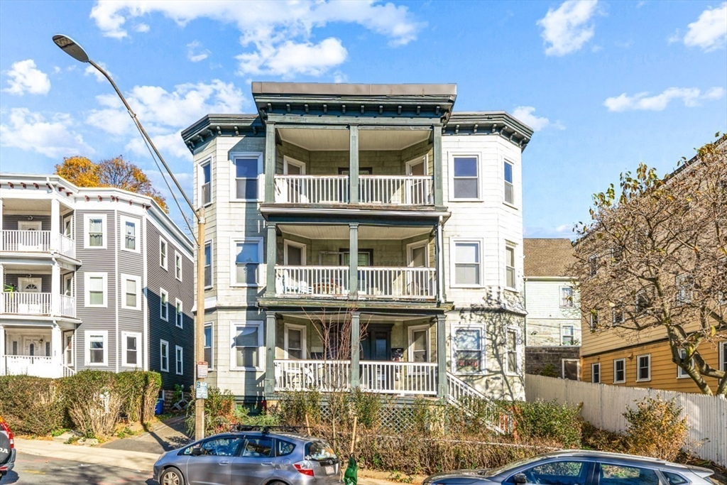 a front view of a residential apartment building with a yard