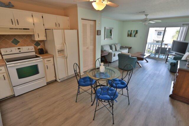 a view of kitchen with sink and wooden floor