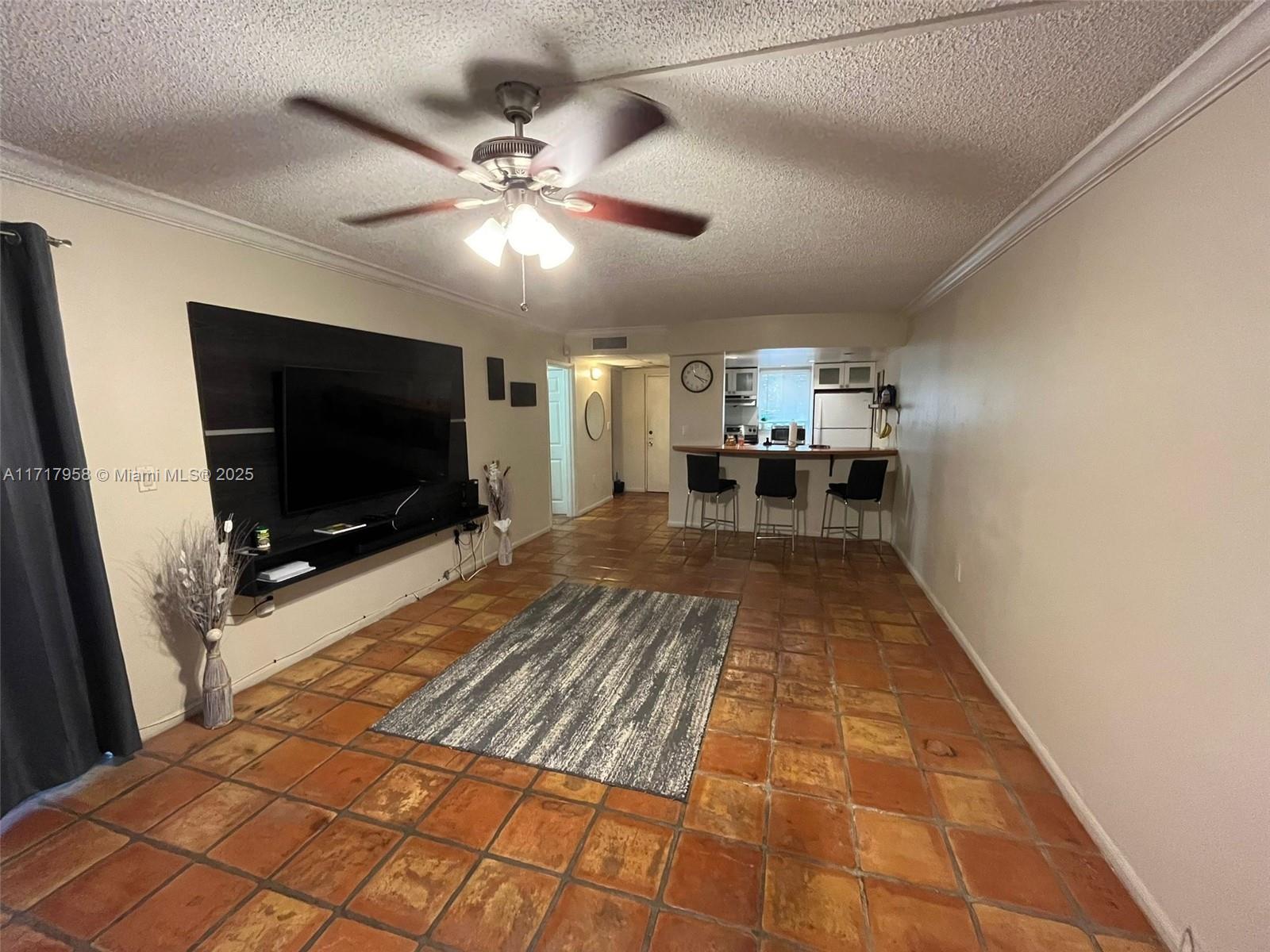 a living room with a flat screen tv and a dining table