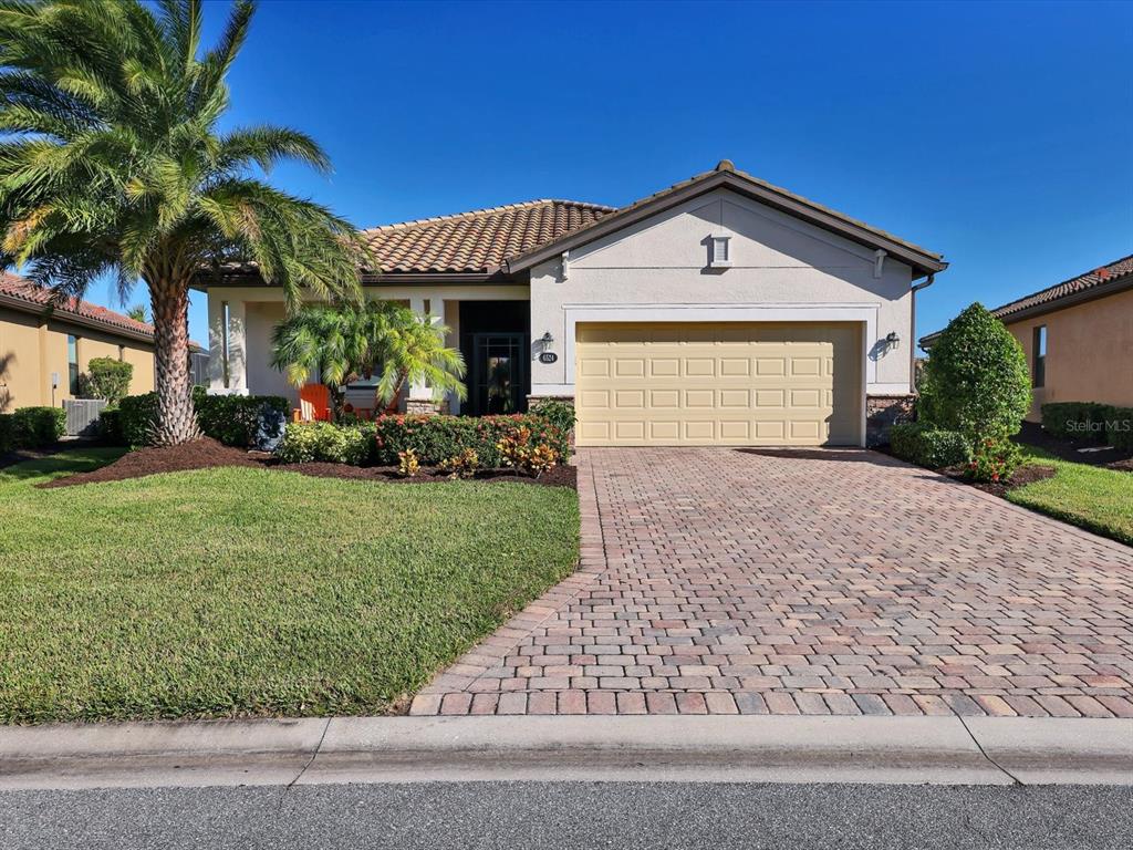 a front view of a house with a yard and garage