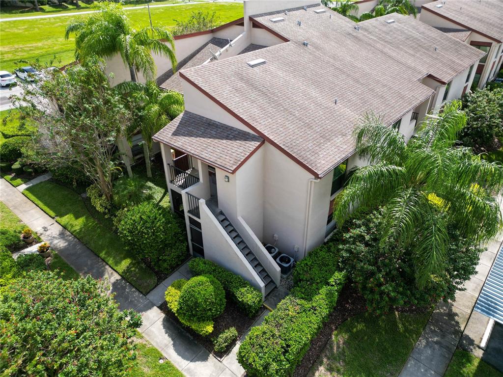 an aerial view of a house with a yard and potted plants