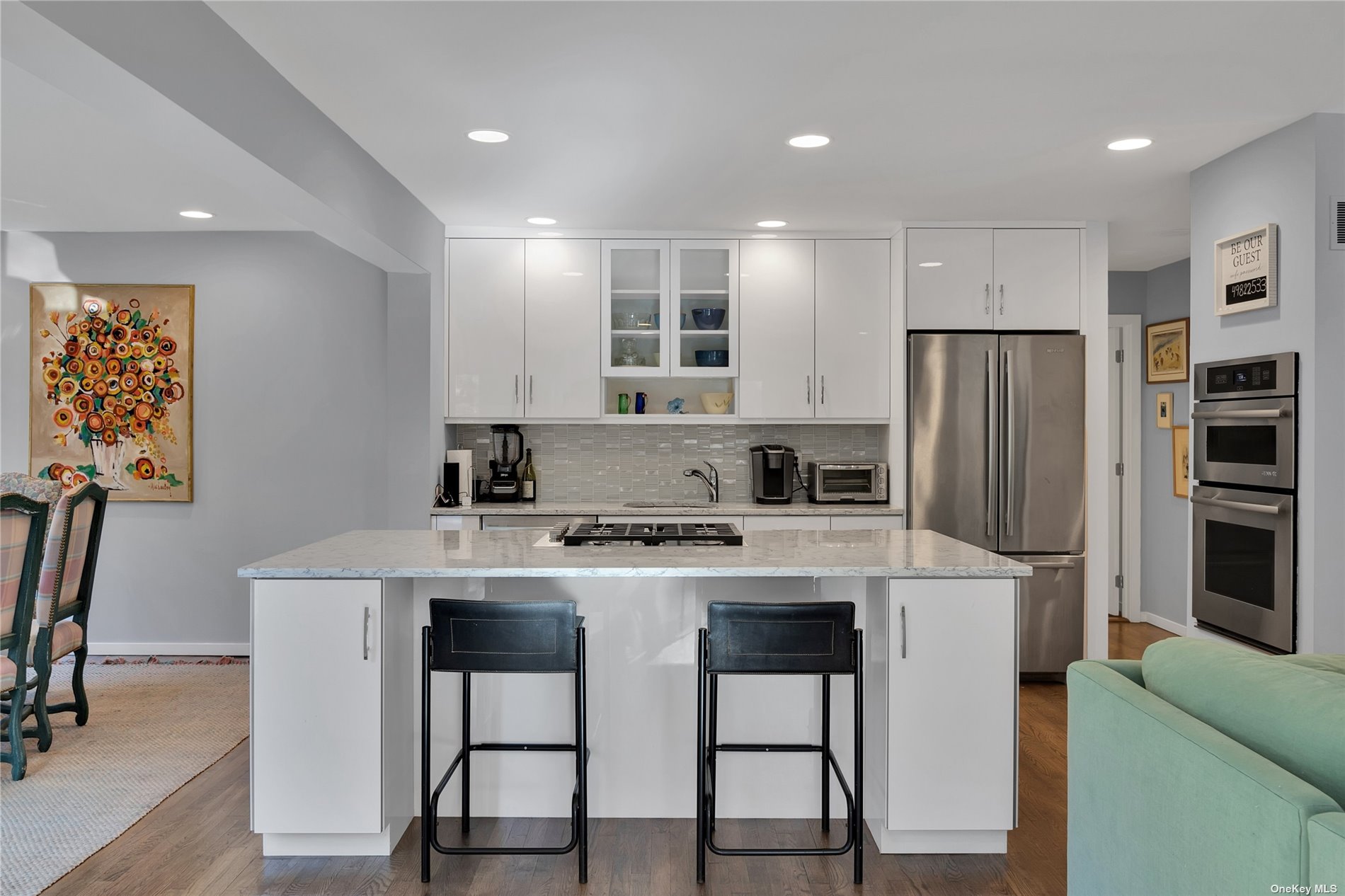 a kitchen with a stove a refrigerator and furniture