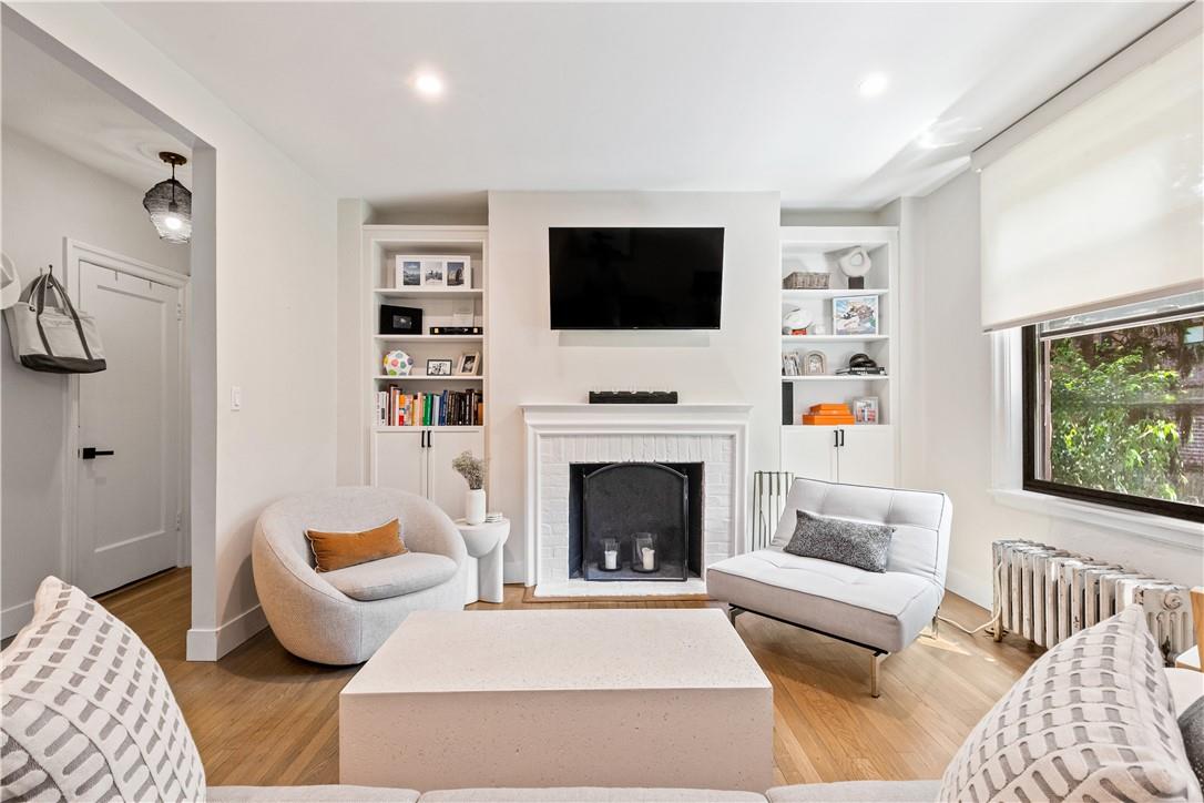 a living room with furniture fireplace and window