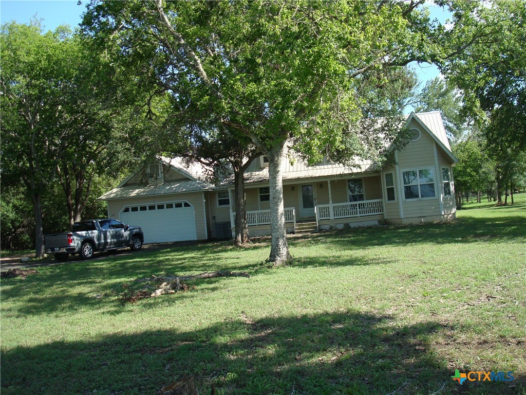 a backyard of a house with yard and tree