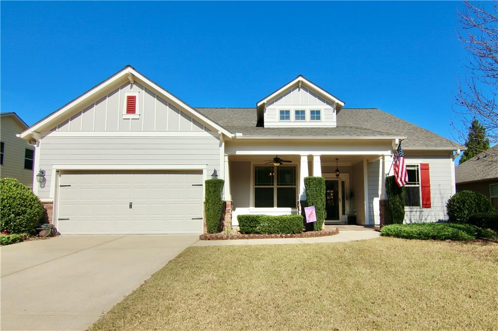 a view of a house with a yard and garage