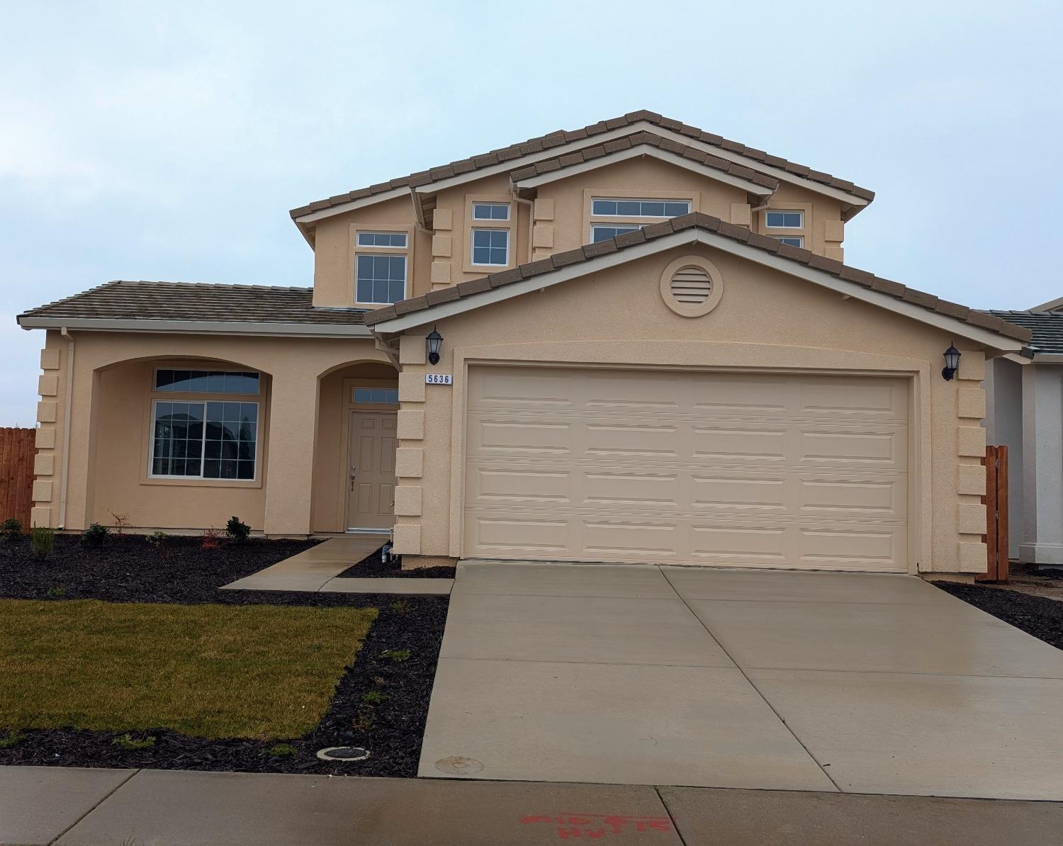 a front view of a house with garage