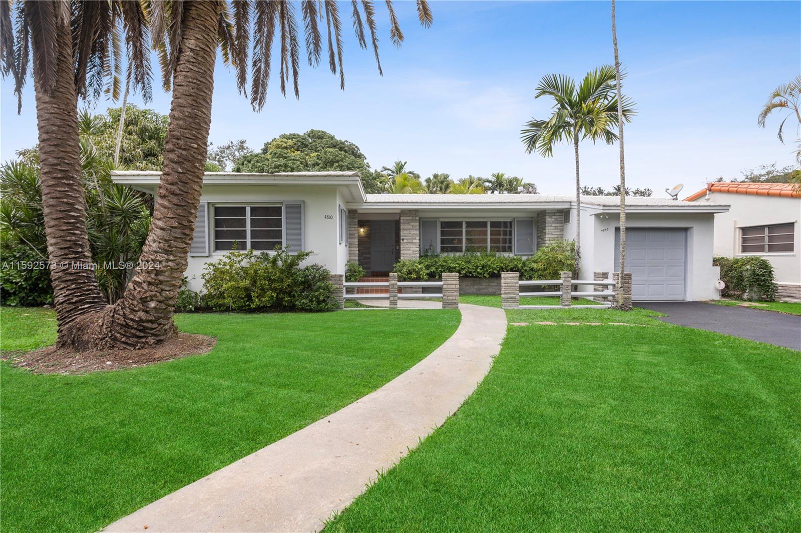 a front view of a house with a garden and patio