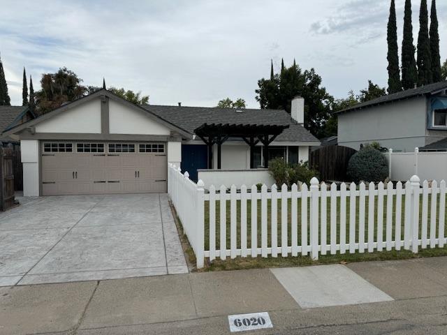 a front view of a house with a fence