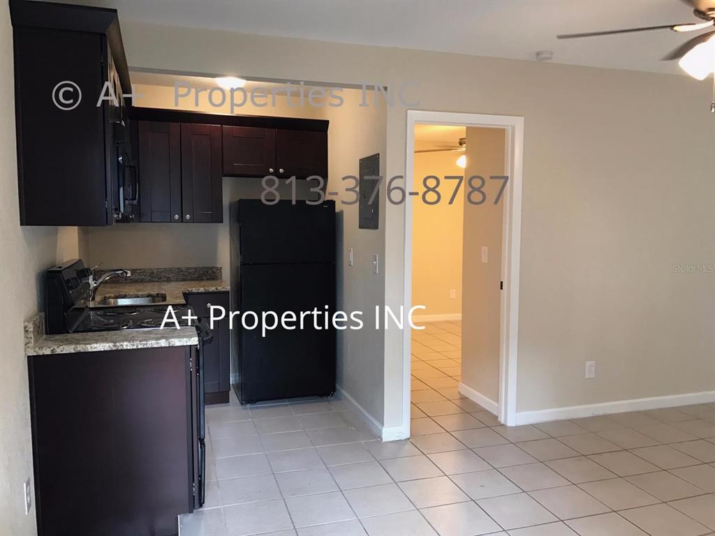 a kitchen with stainless steel appliances granite countertop a refrigerator and a stove