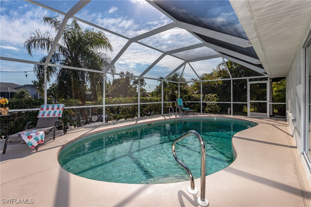 a view of a swimming pool with a porch and furniture