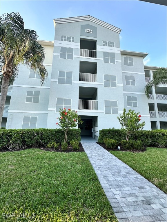 a front view of a building with a yard