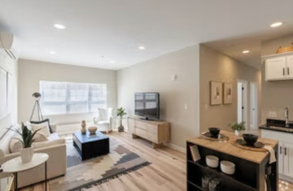 a living room with furniture and a flat screen tv