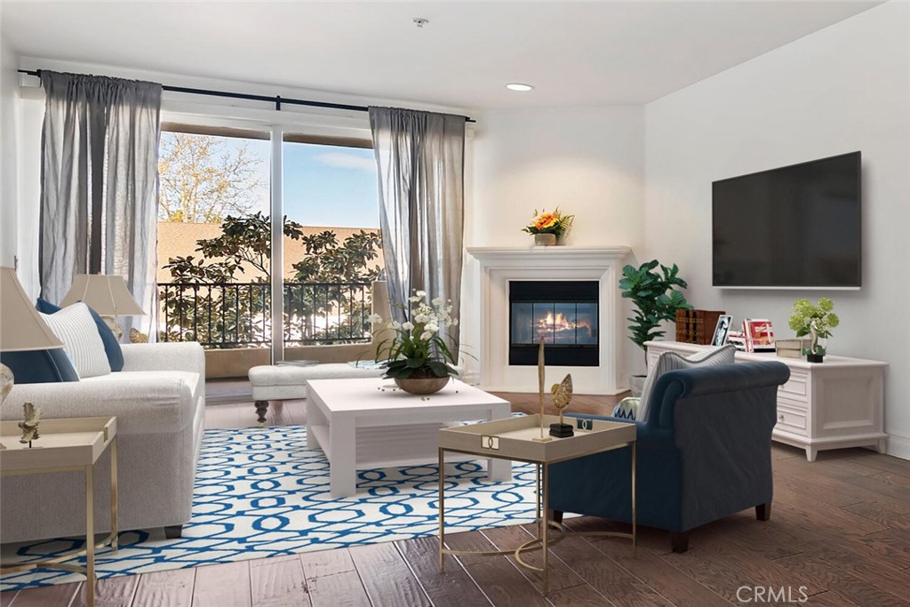 a living room with furniture a fireplace and a flat screen tv