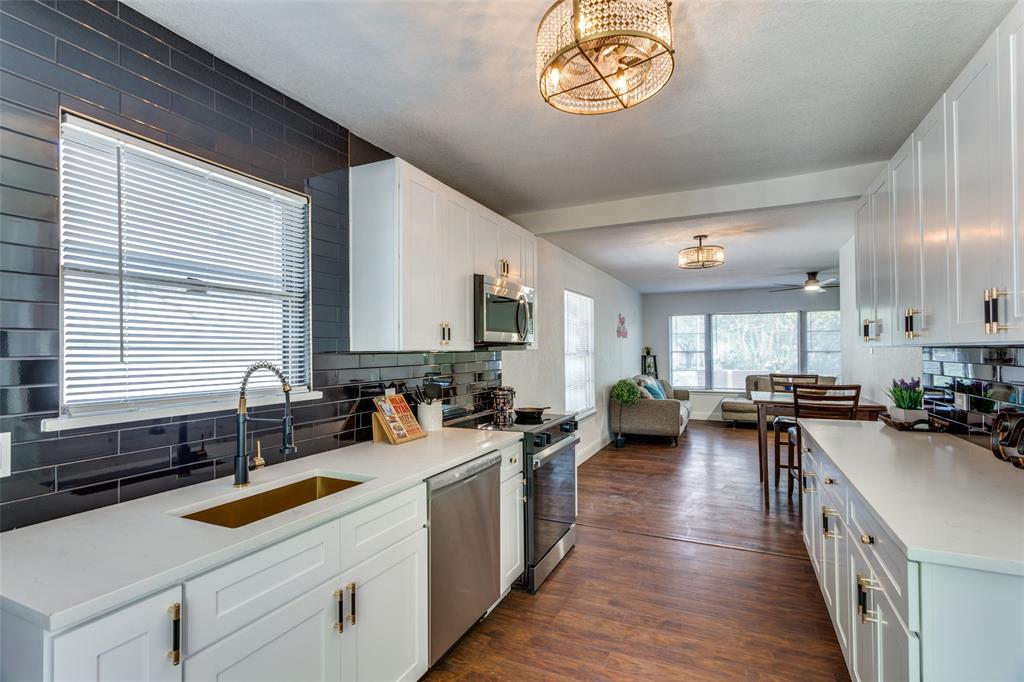 a kitchen with a stove a sink and a refrigerator