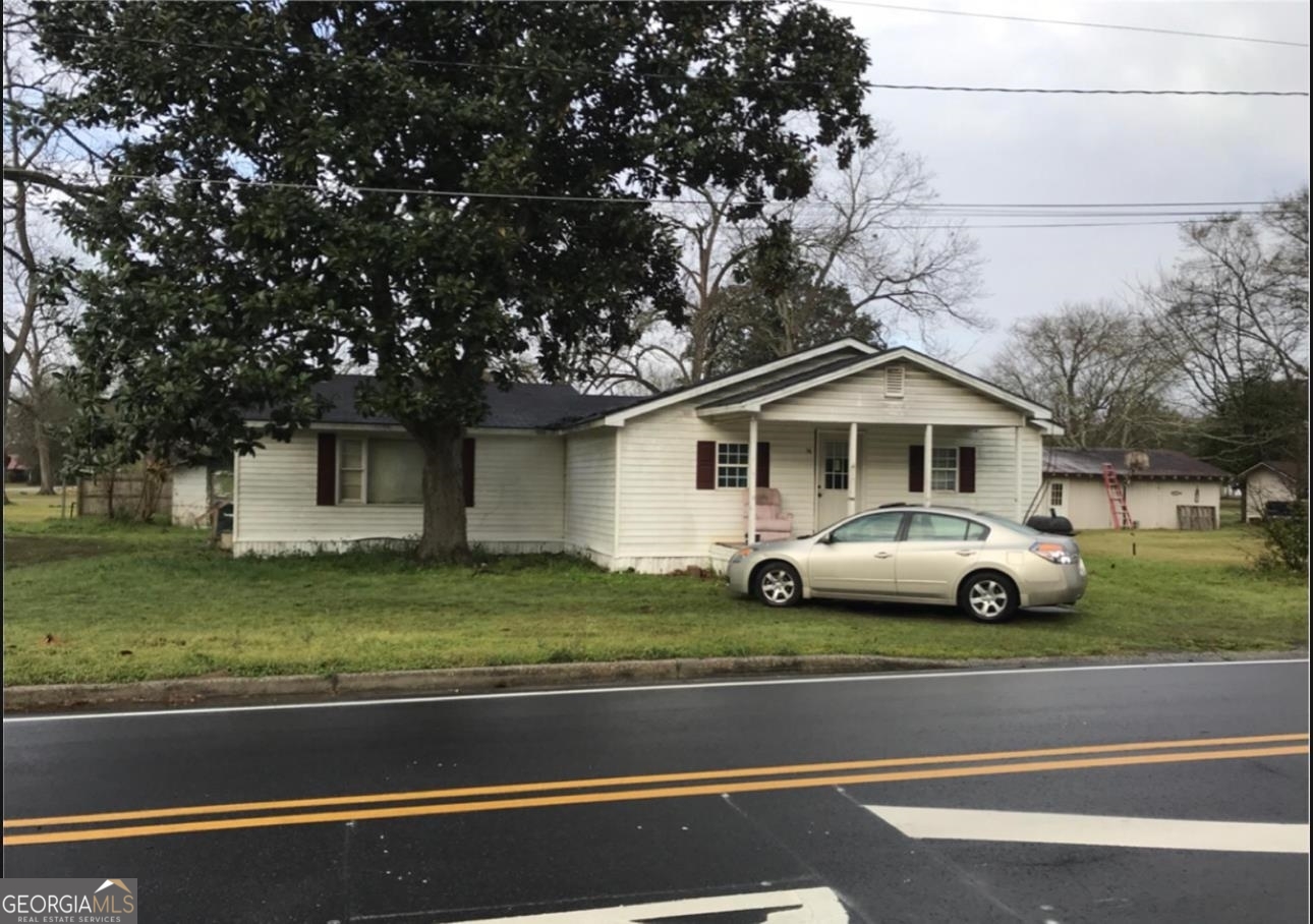 a view of a house with a car parked in front of a house