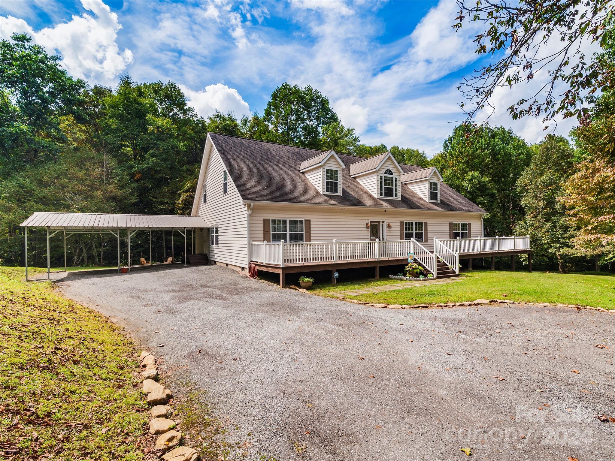 a front view of a house with a yard and trees