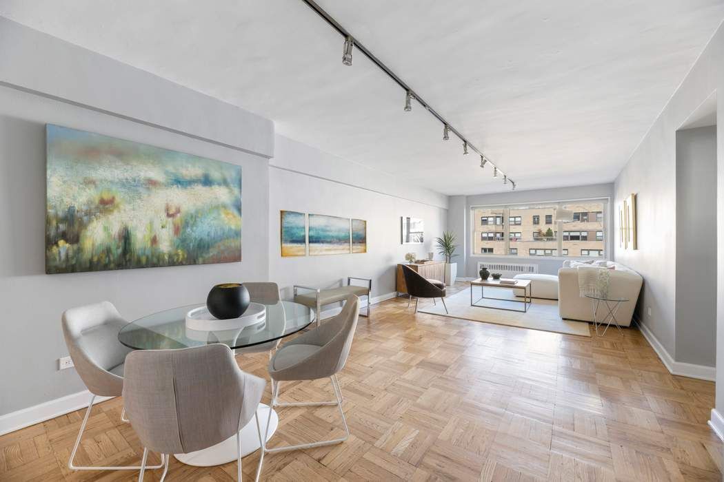 a living room with furniture and a painting on the wall