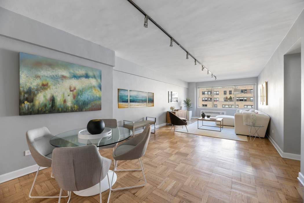 a living room with furniture and a painting on the wall