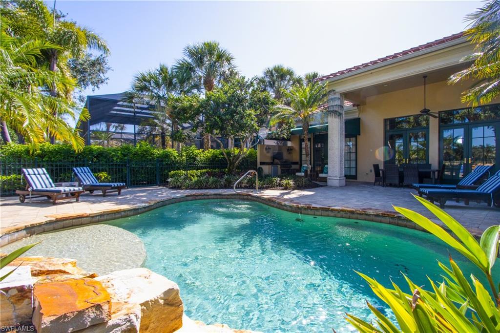 a view of a swimming pool with sitting area and furniture