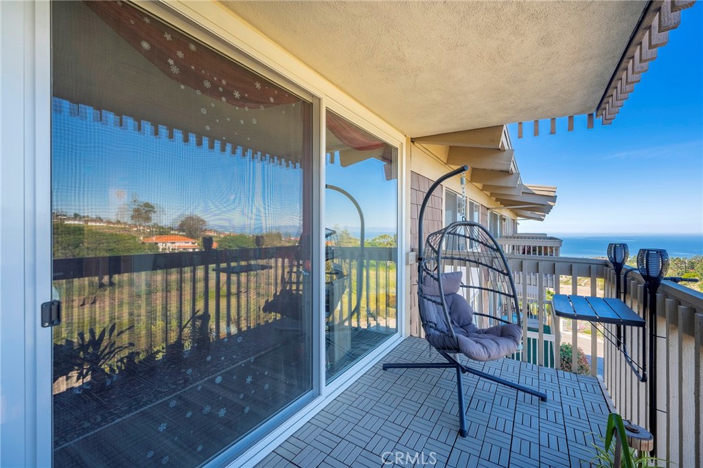 a view of balcony with furniture and wooden floor