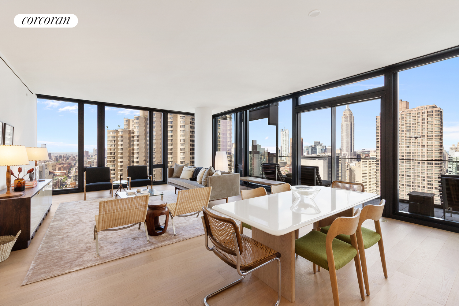 a living room with furniture and large windows