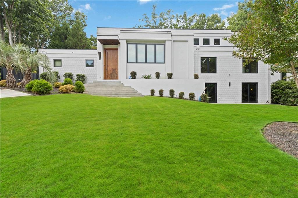 a front view of a house with a garden