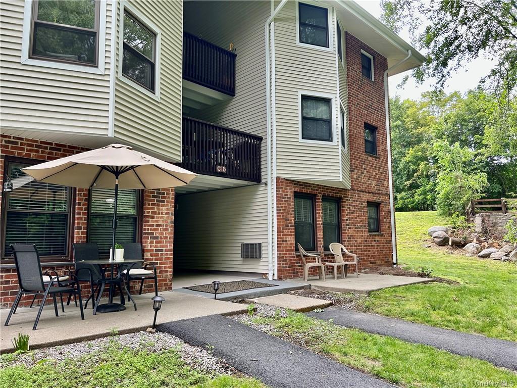 a front view of a house with yard and sitting area