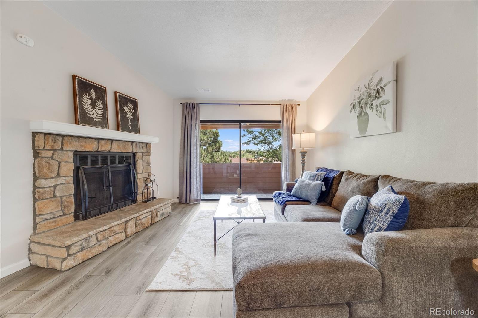 a living room with furniture a window and a fireplace