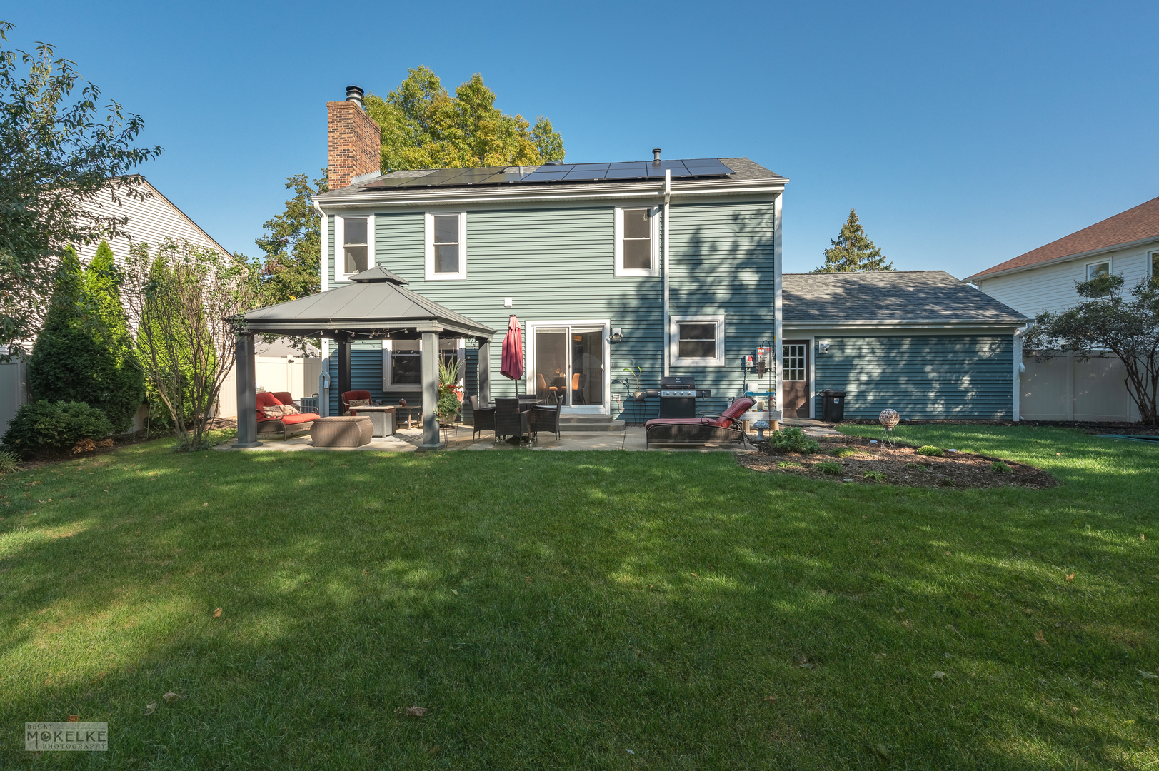 a view of a house with a yard patio and fire pit