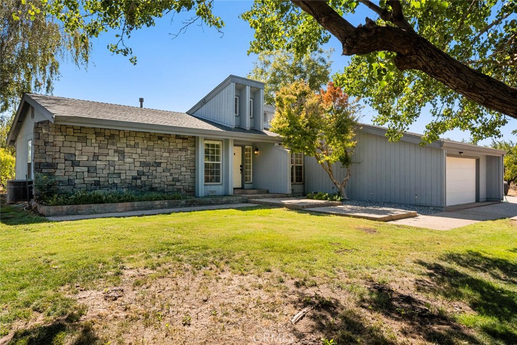 a view of a house with pool and a yard