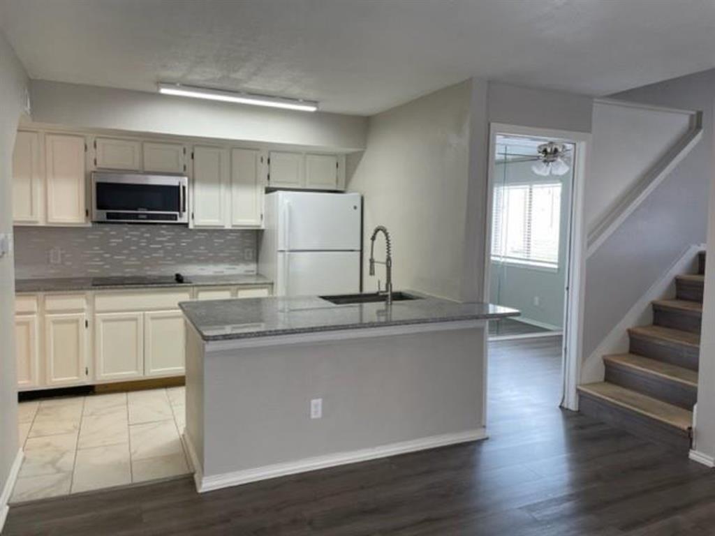 a kitchen with stainless steel appliances a sink and microwave