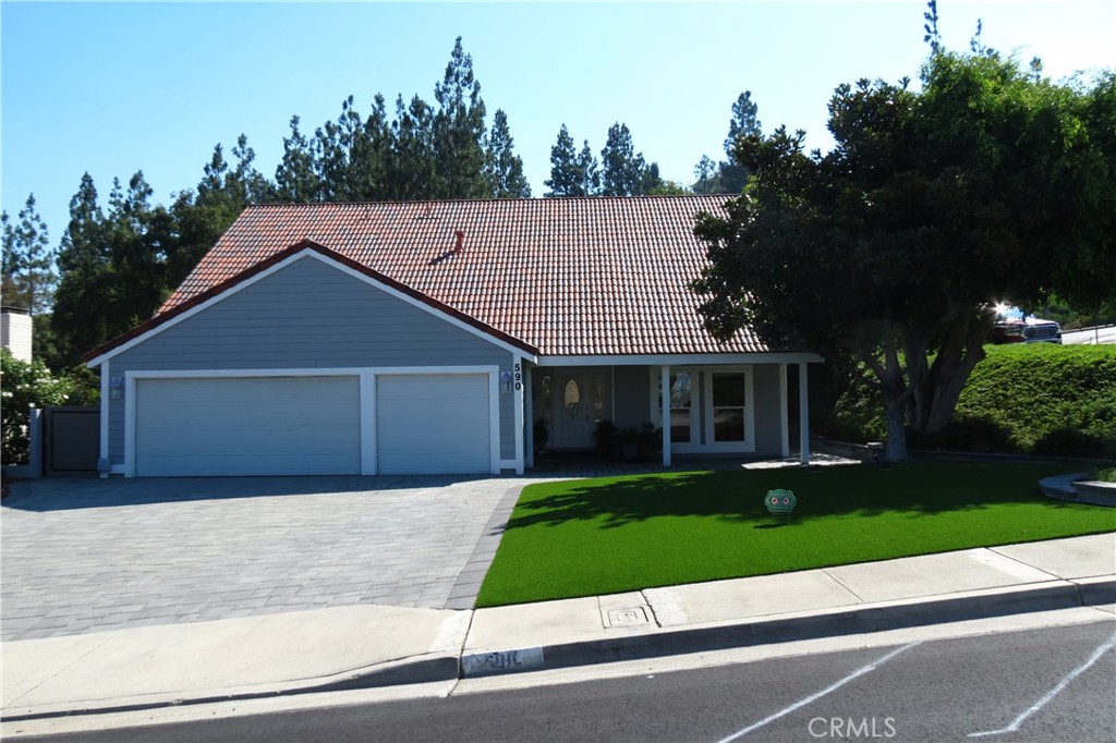 a front view of house with yard and green space