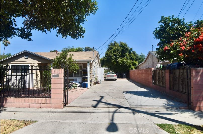 a view of a house with a yard and tree s