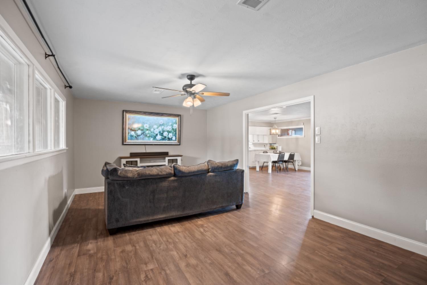 a living room with furniture and wooden floor