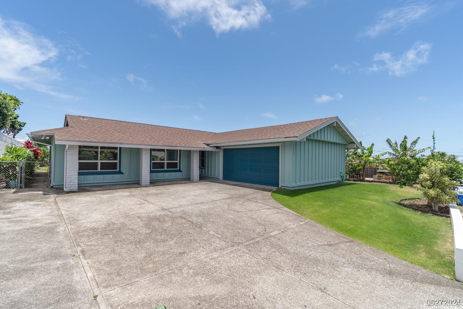 a front view of house with yard and green space