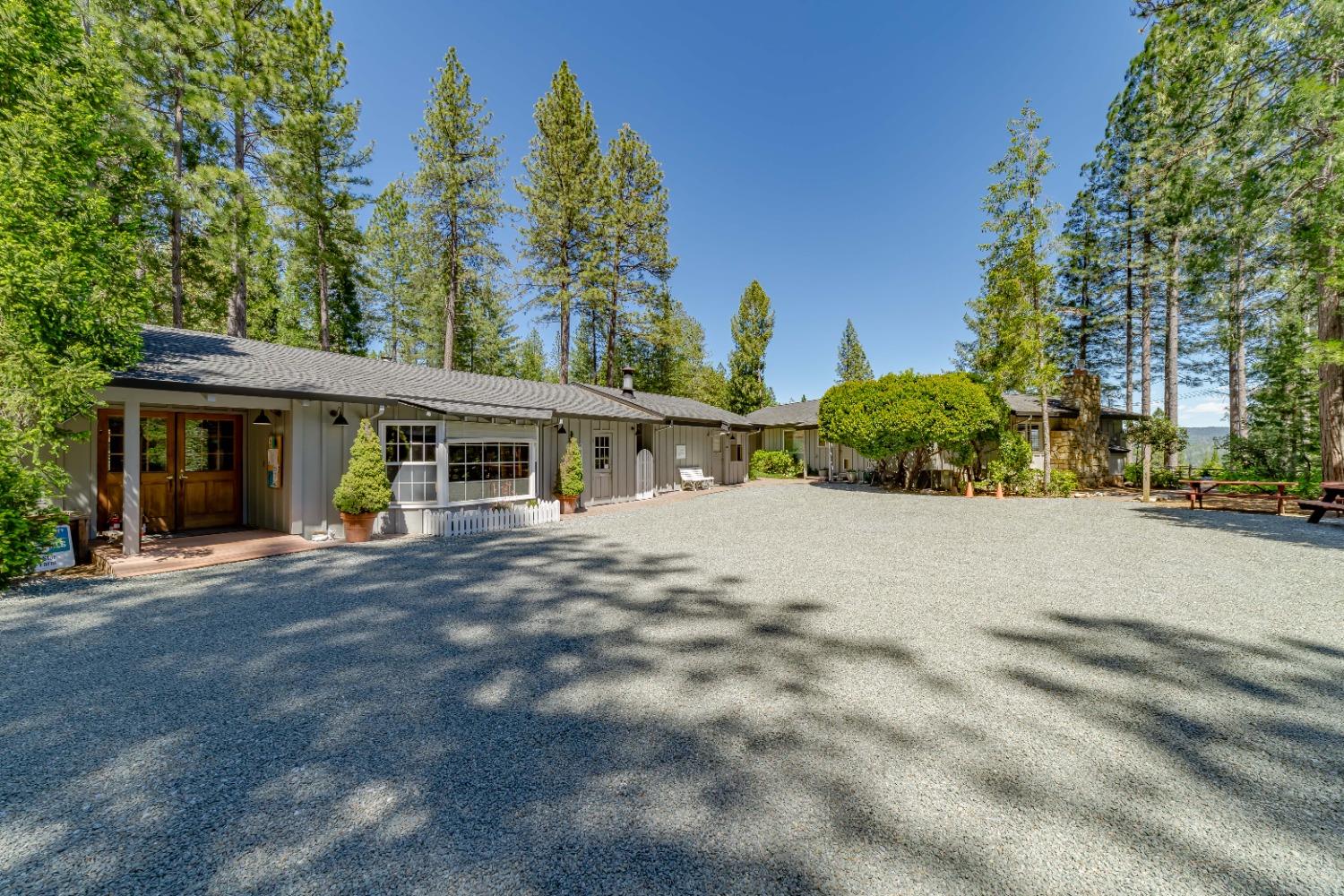 a front view of a house with a yard and trees