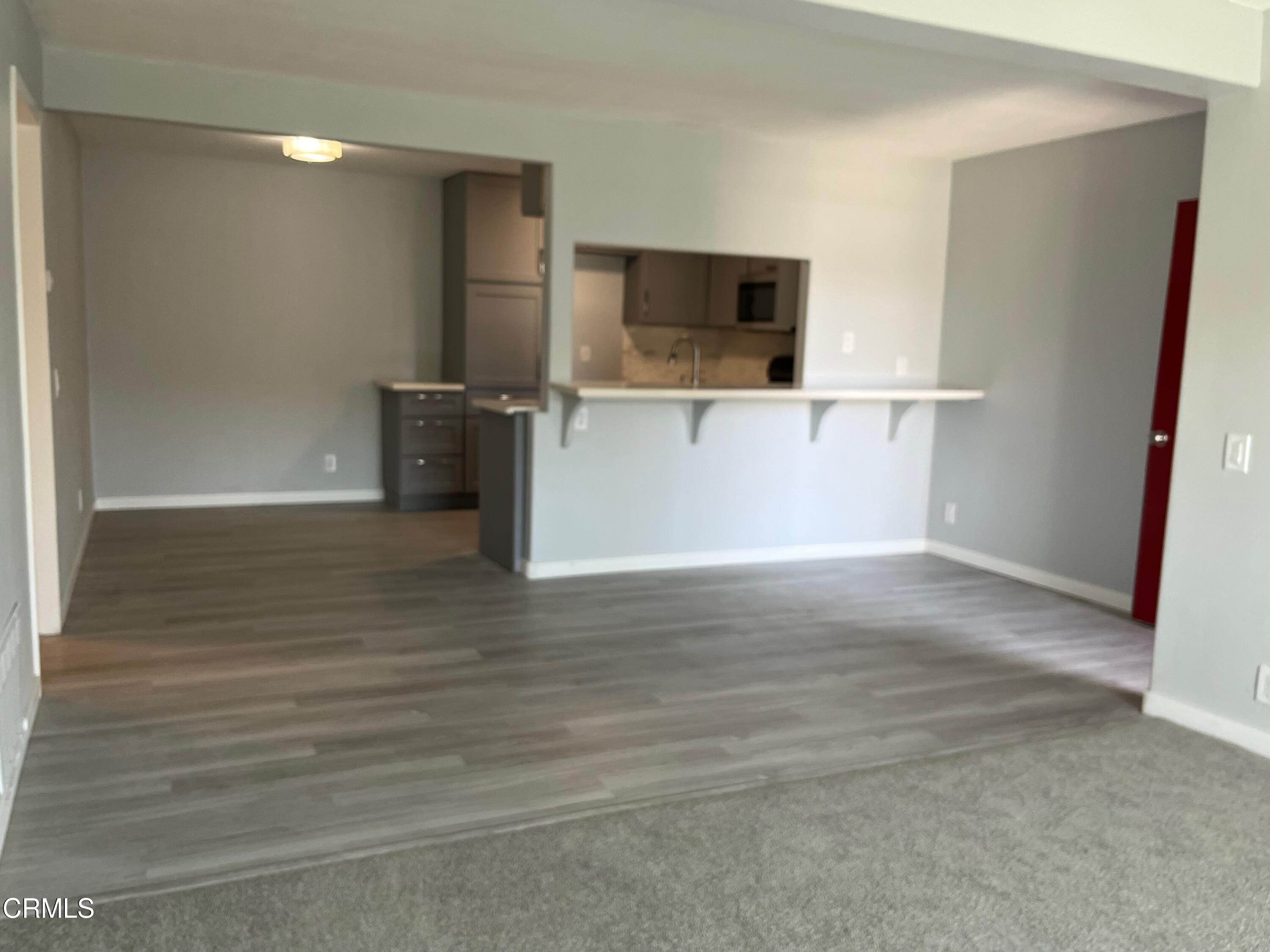 a view of a kitchen with a sink and a microwave