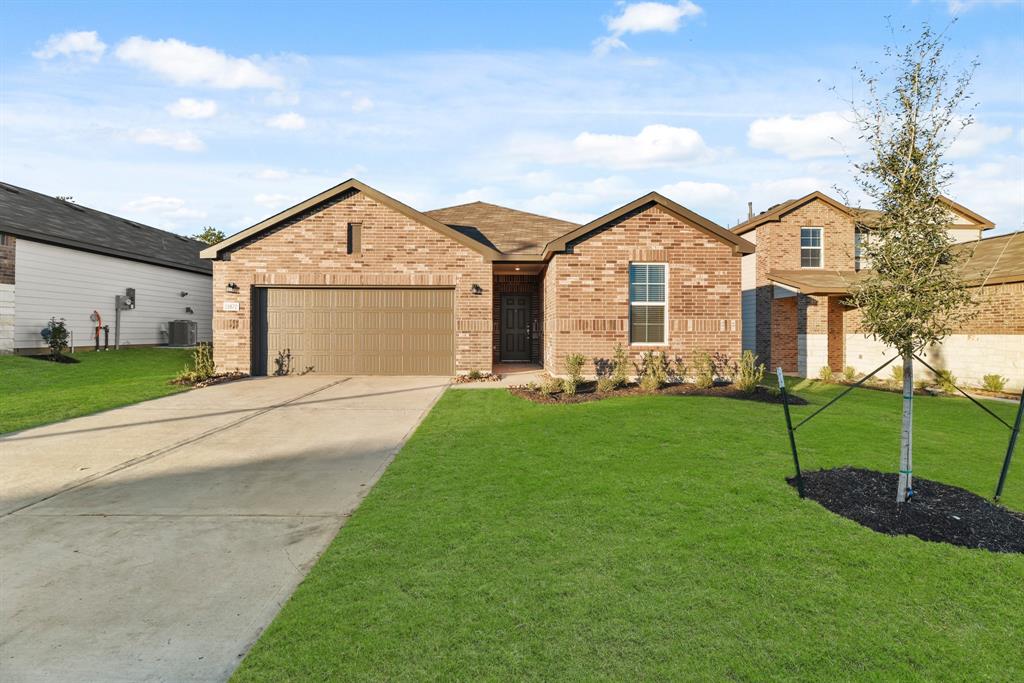 a front view of a house with a garden and yard