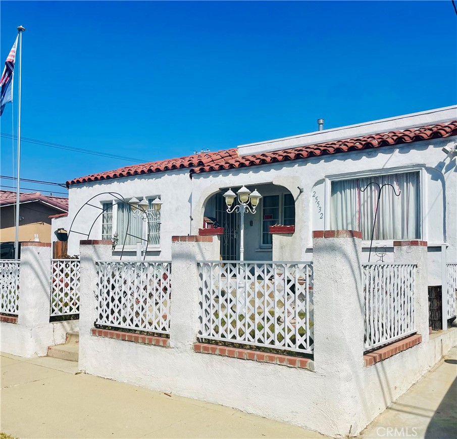 a view of a house with wooden fence